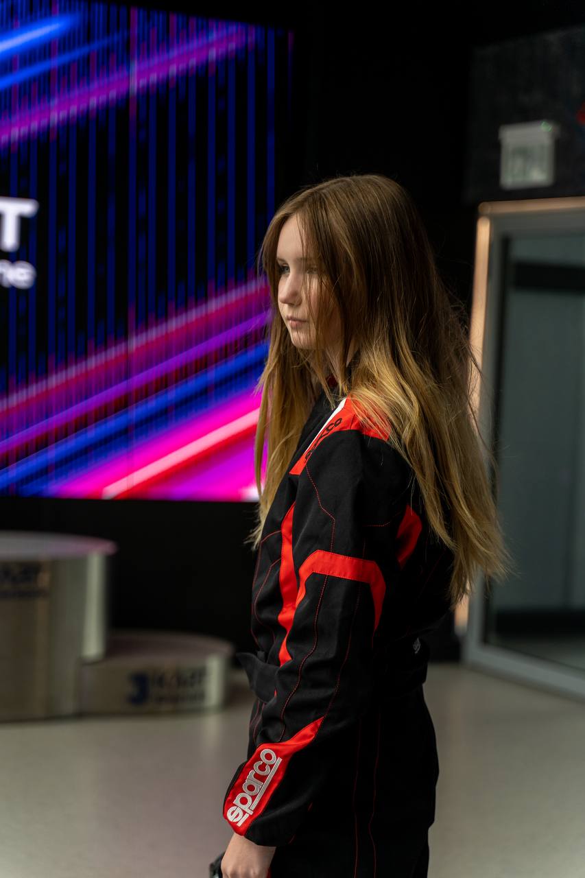 Kseniia standing in racing gear